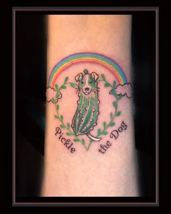 62 Beautiful Remembrance Tattoos for Dogs: A Heartfelt Tribute 52 Whimsical pickle dog memorial tattoo with rainbow and text 'Pickle the Dog' in green wreath