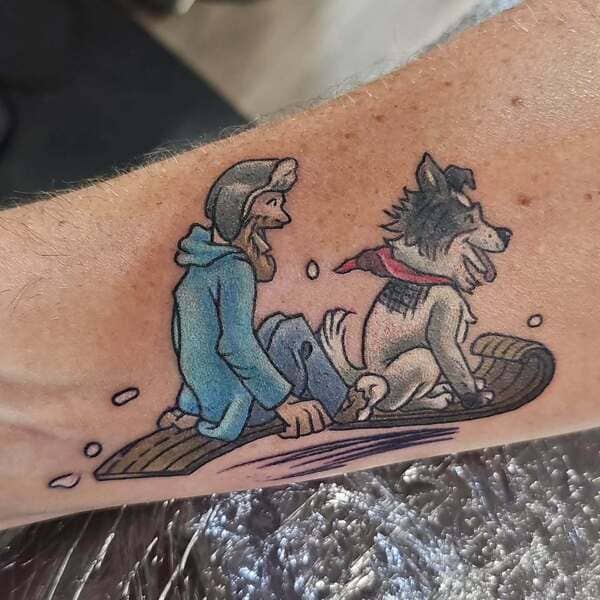 62 Beautiful Remembrance Tattoos for Dogs: A Heartfelt Tribute 59 Colorful snowboarding scene with person and dog memorial tatto