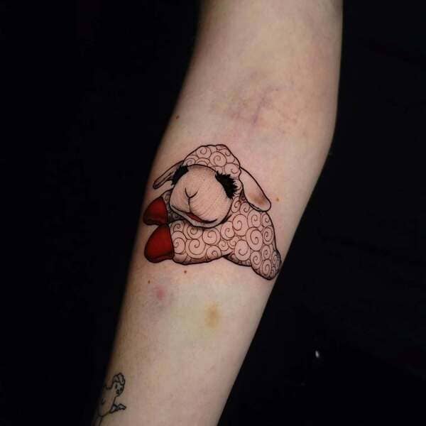 62 Beautiful Remembrance Tattoos for Dogs: A Heartfelt Tribute 44 Cute sleeping sheep with red bow dog memorial tattoo on forearm