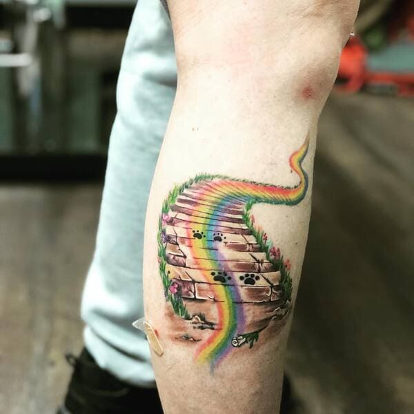 62 Beautiful Remembrance Tattoos for Dogs: A Heartfelt Tribute 57 Rainbow stairway to heaven memorial tattoo with paw prints and floral details