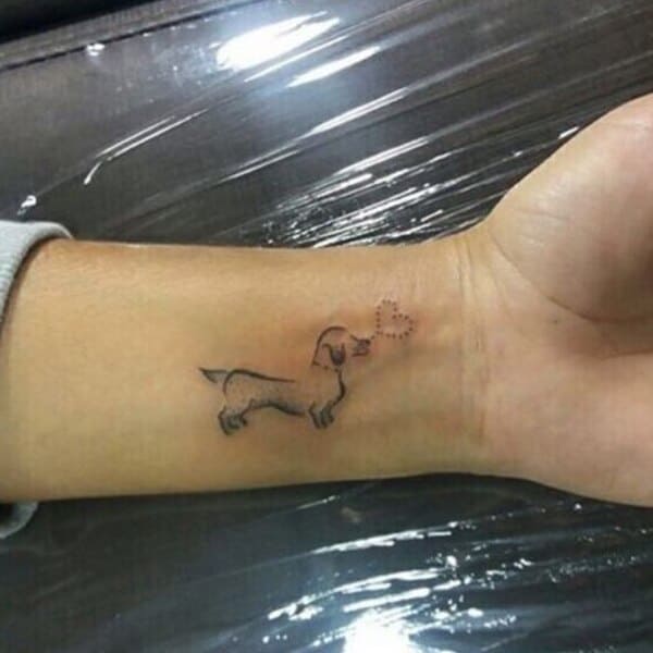 62 Beautiful Remembrance Tattoos for Dogs: A Heartfelt Tribute 32 Dachshund silhouette with dotted heart memorial tattoo on wrist