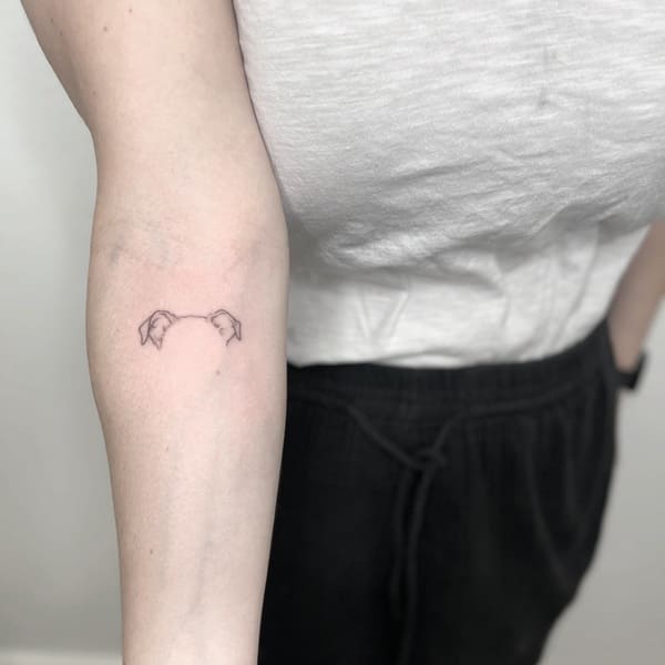 62 Beautiful Remembrance Tattoos for Dogs: A Heartfelt Tribute 30 Ultra minimal dog ear outline memorial tattoo on forearm