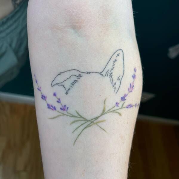 62 Beautiful Remembrance Tattoos for Dogs: A Heartfelt Tribute 22 Delicate dog ear outline with purple lavender flowers memorial tattoo