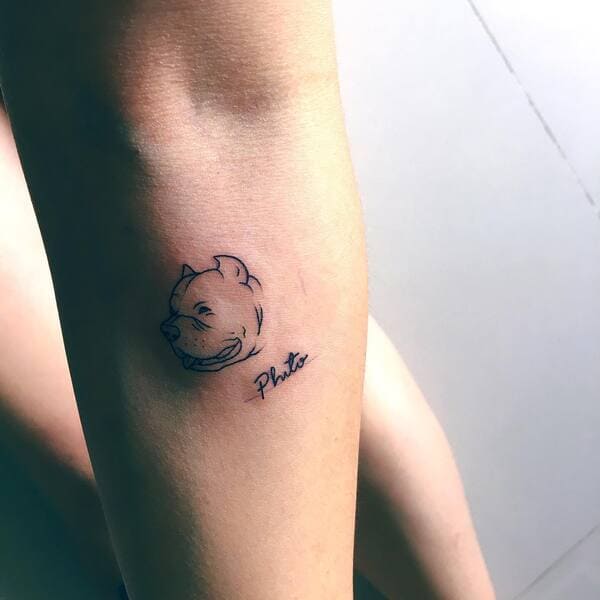 62 Beautiful Remembrance Tattoos for Dogs: A Heartfelt Tribute 36 Smiling Pitbull portrait memorial tattoo with name Pluto in minimalist style