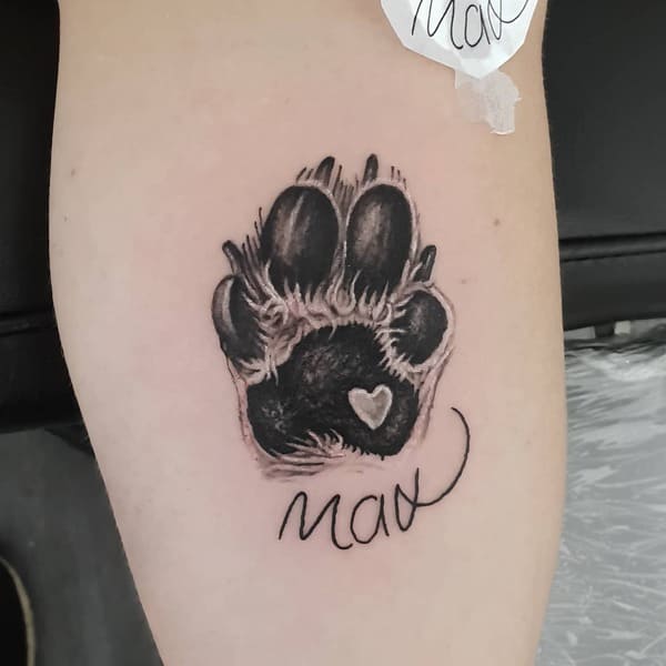 62 Beautiful Remembrance Tattoos for Dogs: A Heartfelt Tribute 43 Detailed dog paw print memorial tattoo with tiny heart and name Max
