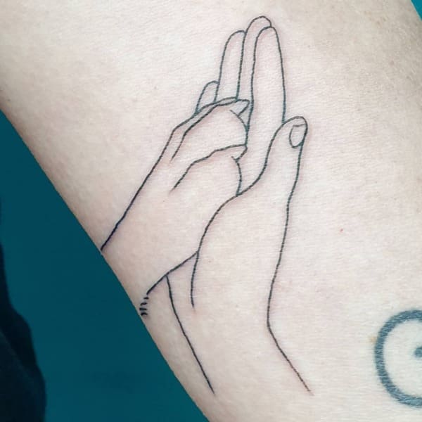 62 Beautiful Remembrance Tattoos for Dogs: A Heartfelt Tribute 20 Simple line art hand holding dog paw remembrance tattoo