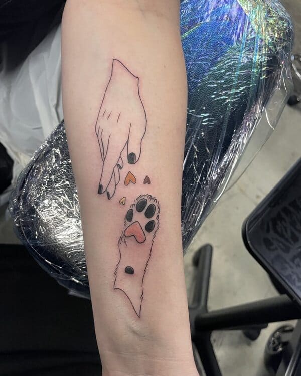 62 Beautiful Remembrance Tattoos for Dogs: A Heartfelt Tribute 15 Minimalist dog memorial tattoo showing human hand and dog paw with heart details, simple line art style