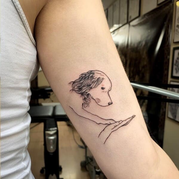 62 Beautiful Remembrance Tattoos for Dogs: A Heartfelt Tribute 25 Artistic dog portrait on open palm memorial tattoo design